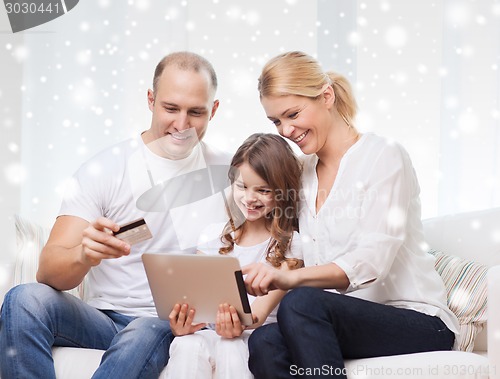 Image of happy family with tablet pc and credit card