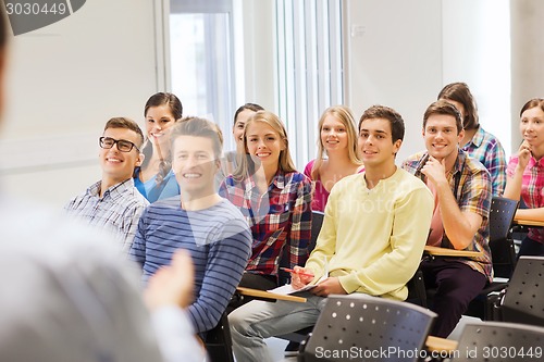 Image of group of students and teacher with notebook