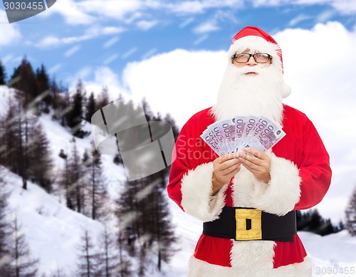 Image of man in costume of santa claus with euro money