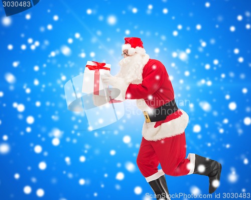 Image of man in costume of santa claus with gift box