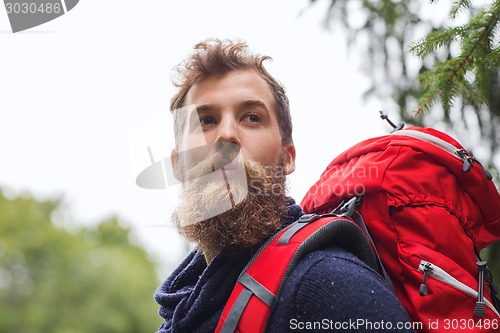 Image of man with beard and backpack hiking