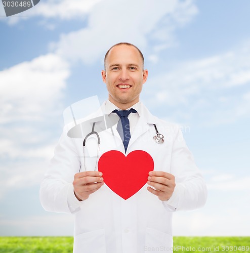 Image of smiling male doctor with red heart and stethoscope