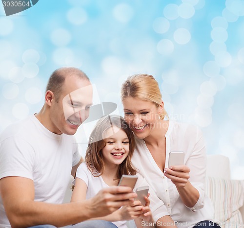 Image of happy family with smartphones