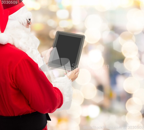 Image of man in costume of santa claus with tablet pc