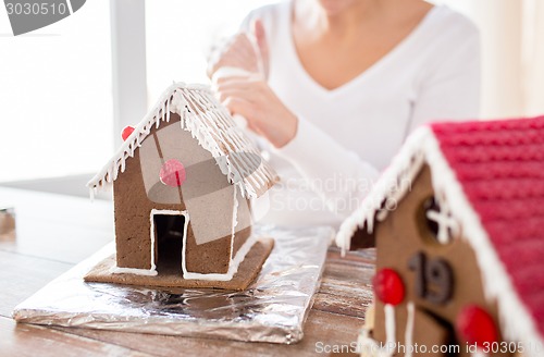 Image of close up of woman making gingerbread houses