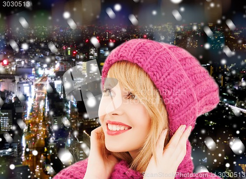 Image of smiling young woman in winter clothes