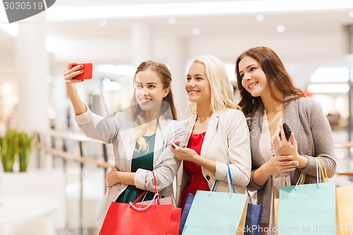 Image of women with smartphones shopping and taking selfie