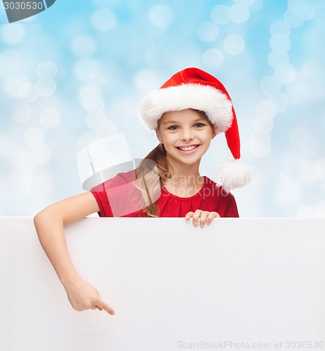 Image of girl in santa helper hat with blank white board