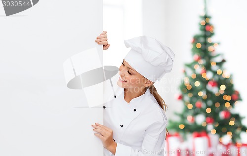 Image of smiling female chef with white blank board