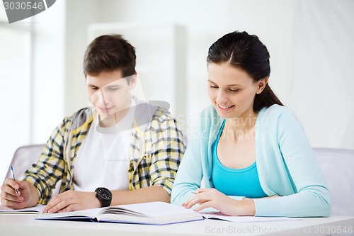 Image of students with textbooks and books at school