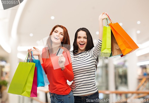 Image of two smiling teenage girls with shopping bags