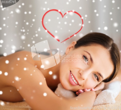 Image of woman in spa salon with hot stones