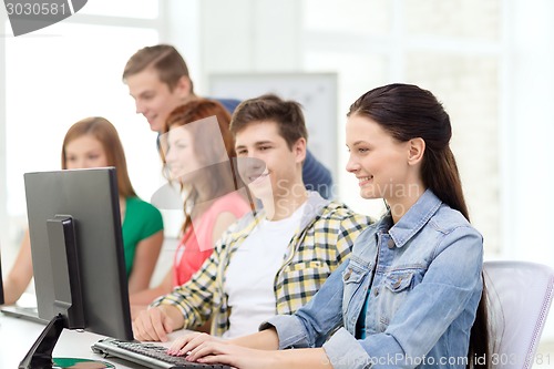 Image of female student with classmates in computer class