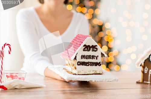 Image of close up of woman showing gingerbread house