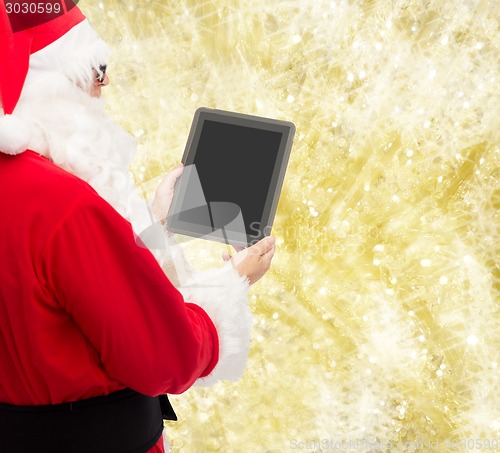 Image of man in costume of santa claus with tablet pc