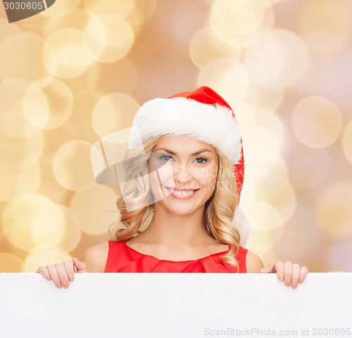 Image of woman in santa helper hat with blank white board