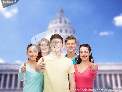 Image of group of smiling teenagers showing ok sign