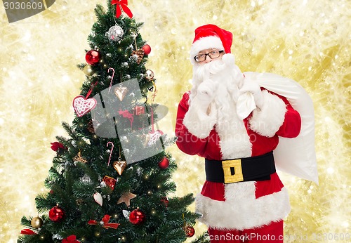 Image of santa claus with bag and christmas tree