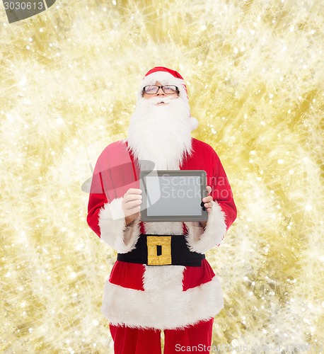Image of man in costume of santa claus with tablet pc