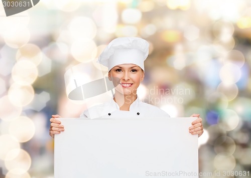 Image of smiling female chef with white blank board