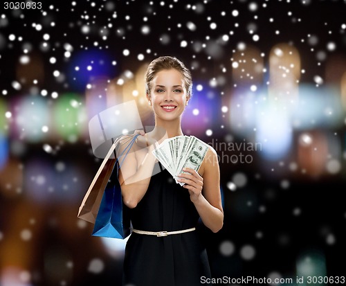 Image of smiling woman in dress with shopping bags