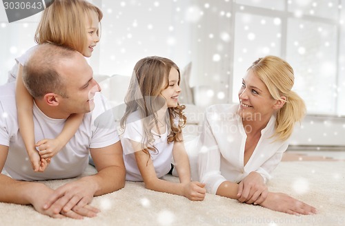 Image of smiling parents and two little girls at home