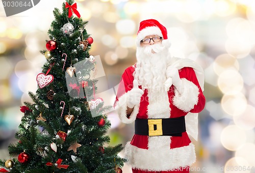 Image of santa claus with bag and christmas tree