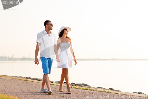 Image of smiling couple walking outdoors