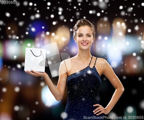 Image of smiling woman with white blank shopping bag