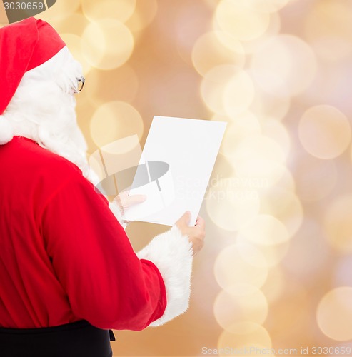 Image of man in costume of santa claus with letter