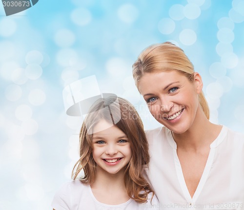 Image of smiling mother and little girl