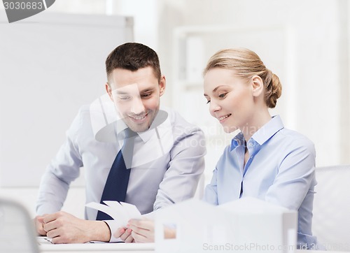 Image of smiling business couple looking at color samples