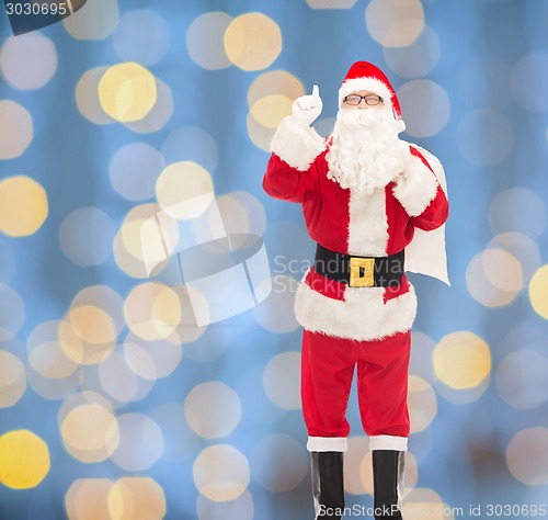 Image of man in costume of santa claus with bag