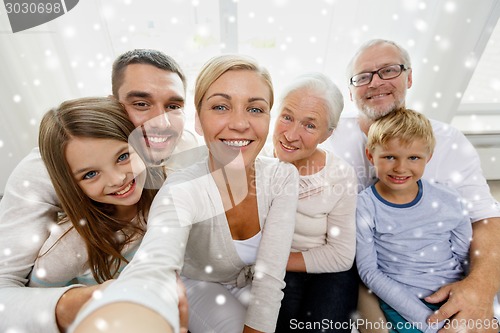 Image of happy family taking selfie at home