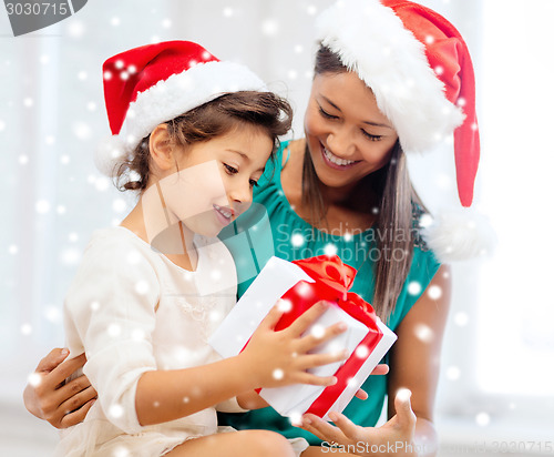 Image of happy mother and child girl with gift box