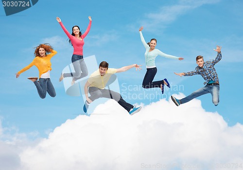 Image of group of smiling teenagers jumping in air