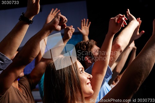 Image of smiling friends at concert in club