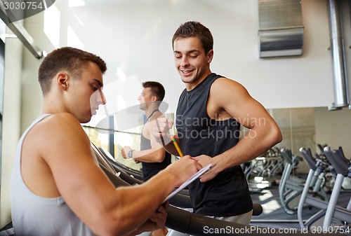 Image of men exercising on treadmill in gym