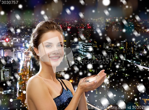 Image of smiling woman in evening dress with diamond