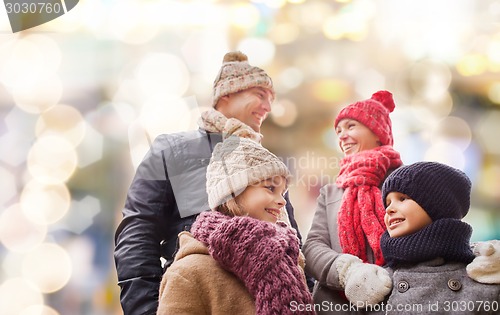 Image of happy family in winter clothes outdoors