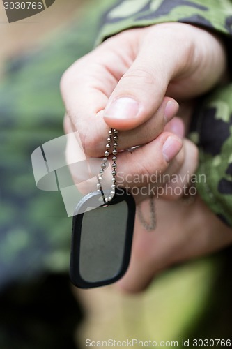 Image of close up of young soldier in military uniform