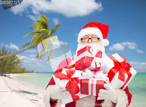 Image of man in costume of santa claus with gift boxes