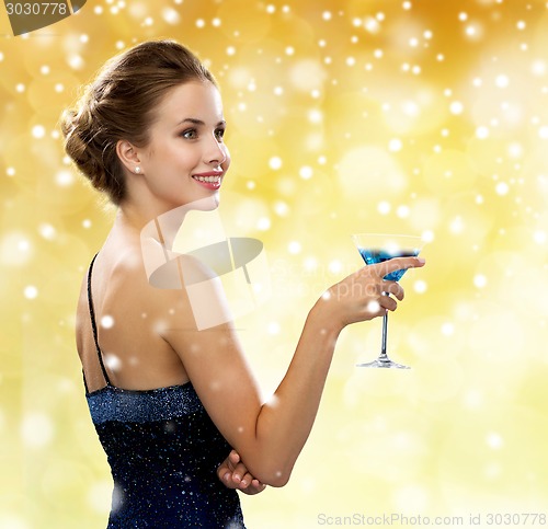 Image of smiling woman holding cocktail