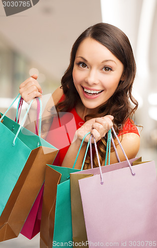 Image of smiling young woman with shopping bags