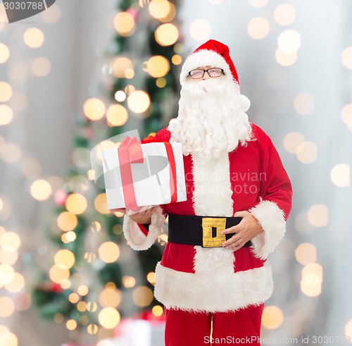 Image of man in costume of santa claus with gift box