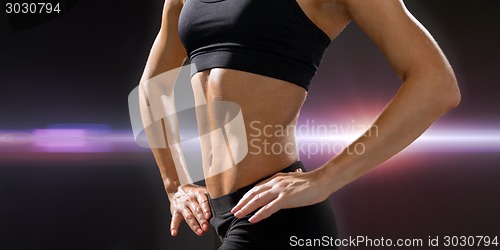 Image of close up of athletic female abs in sportswear