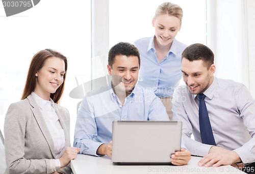 Image of business team working with laptop in office