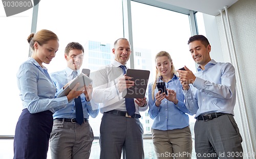 Image of business people with tablet pc and smartphones