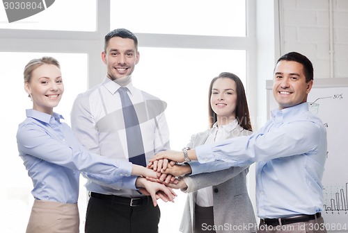 Image of business team celebrating victory in office