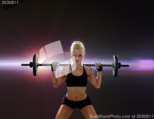 Image of sporty woman exercising with barbell